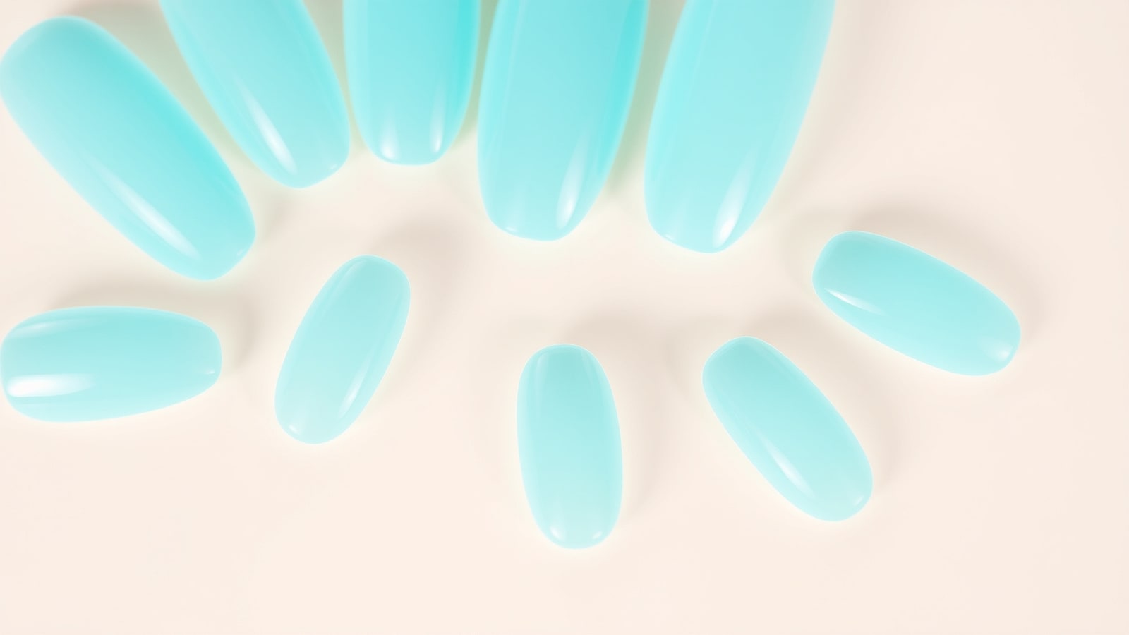 Macro of translucent aqua jelly-gel nails catching the light like water